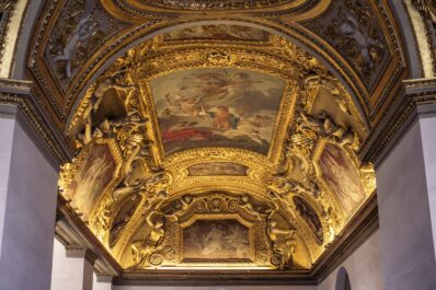 The ornate ceiling inside the Louvre in Paris, France