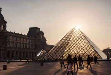 A view of the sun setting over the Louvre in Paris, France