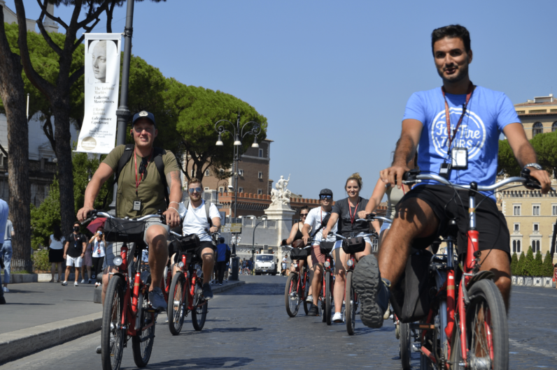 A group of cyclists riding through Rome