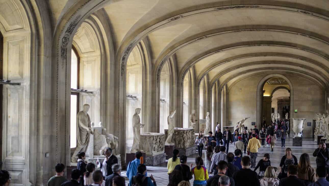 A view of a statue gallery inside the Louvre in Paris, France