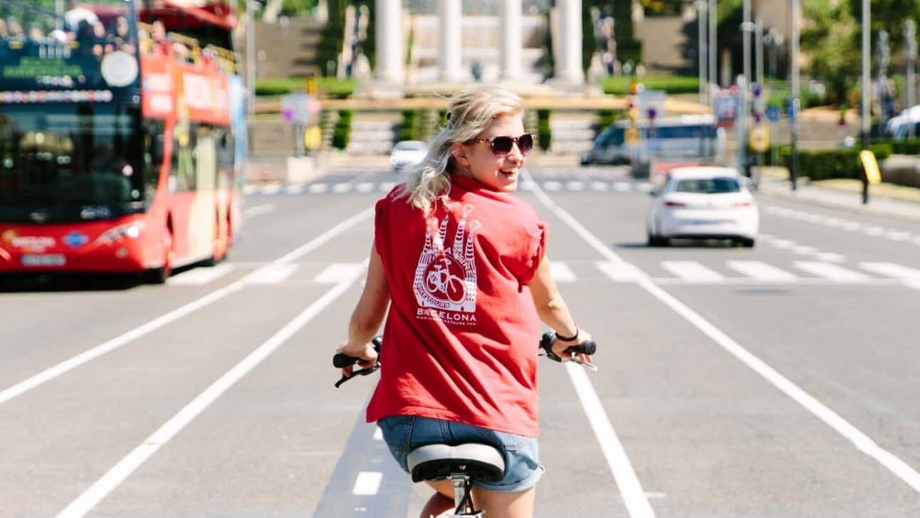 a woman rides her bike in Barcelona, Spain