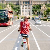 a woman rides her bike in Barcelona, Spain