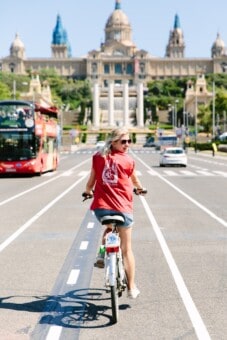 a woman rides her bike in Barcelona, Spain
