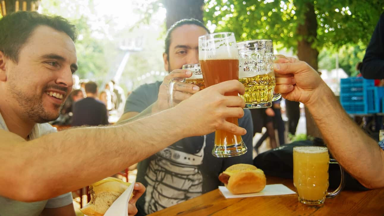 Friends enjoy a beer in a traditional German beer garden in Berlin