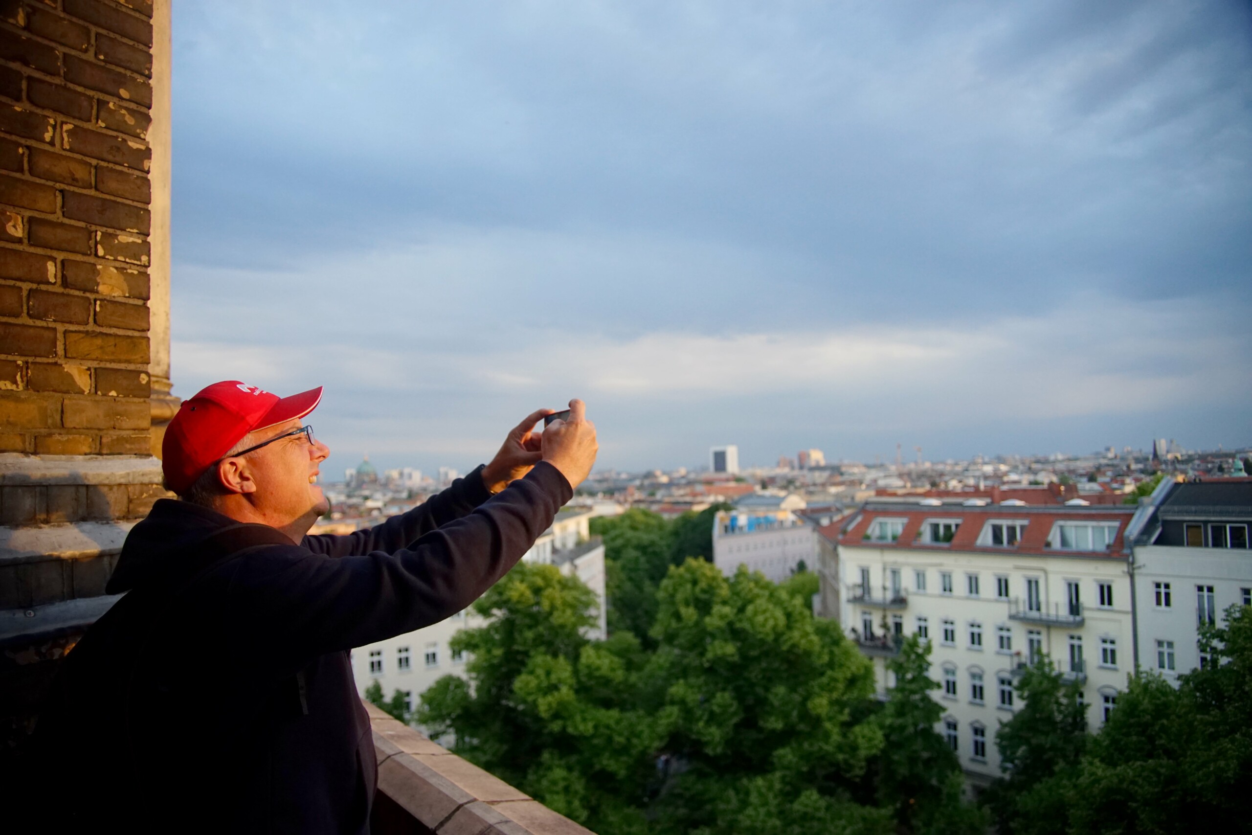 A man takes a photo from the top of Zionskirche church in Berlin, Germany