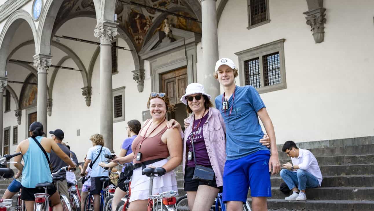 A group poses for a photo in a piazza in Florence, Italy