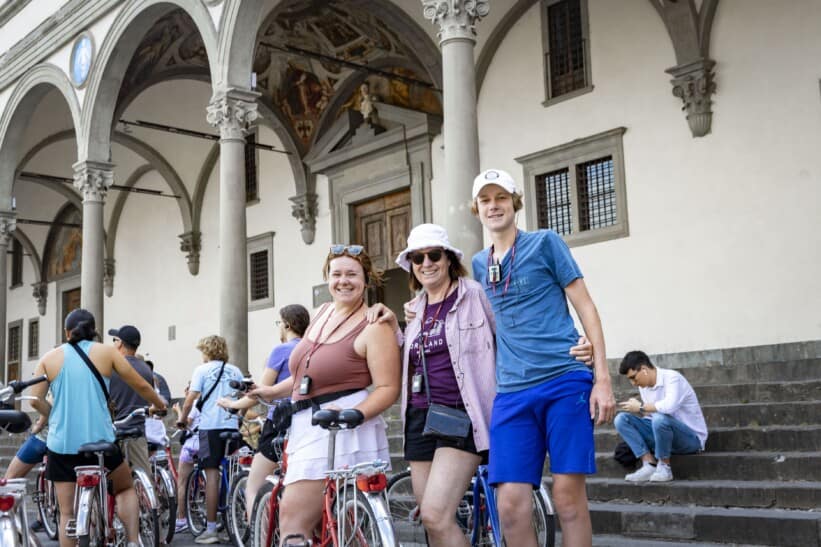 A group poses for a photo in a piazza in Florence, Italy