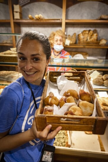 A guide holds up a basket of coccolo in Florence, Italy