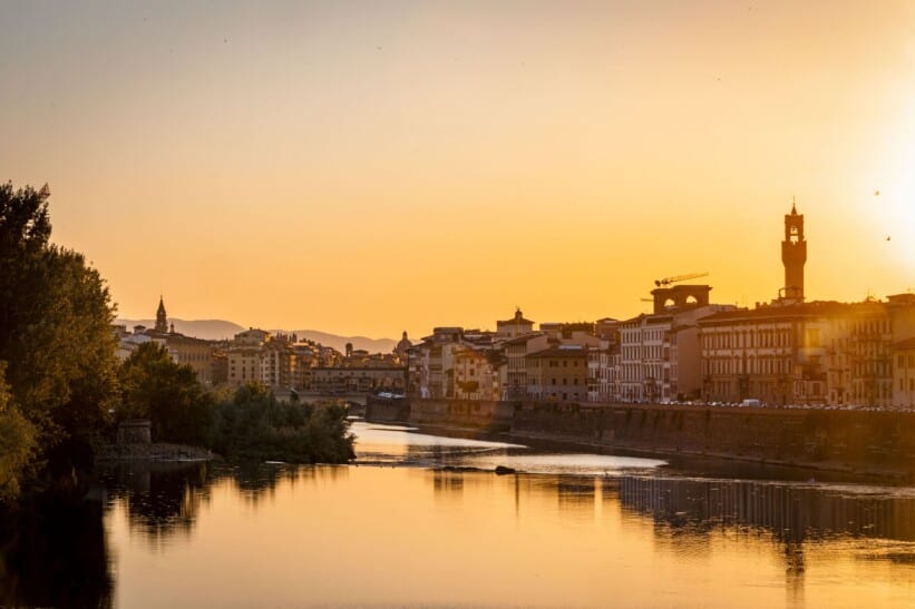 The sun sets over the river Arno in Florence, Italy