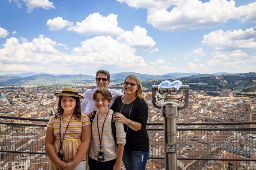 A family poses for a photo on top of the Florence Cathedral