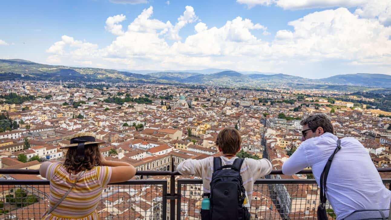A father and his children look over the railing from the top of the Florence Cathedral