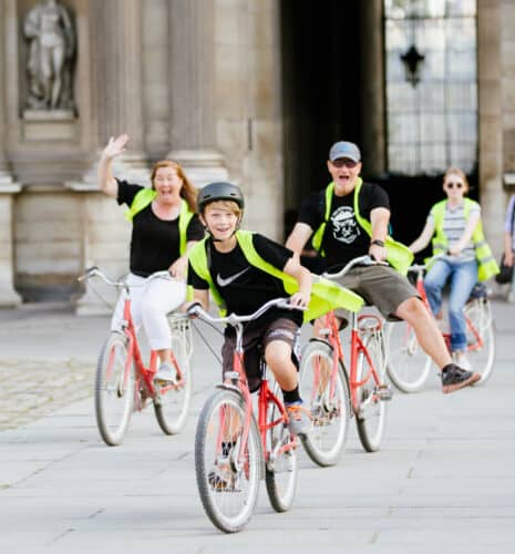 People riding their bikes with vests on.