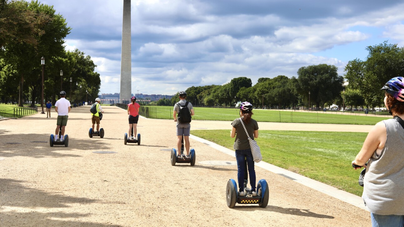 Segwayers ride towards the Washington Monument