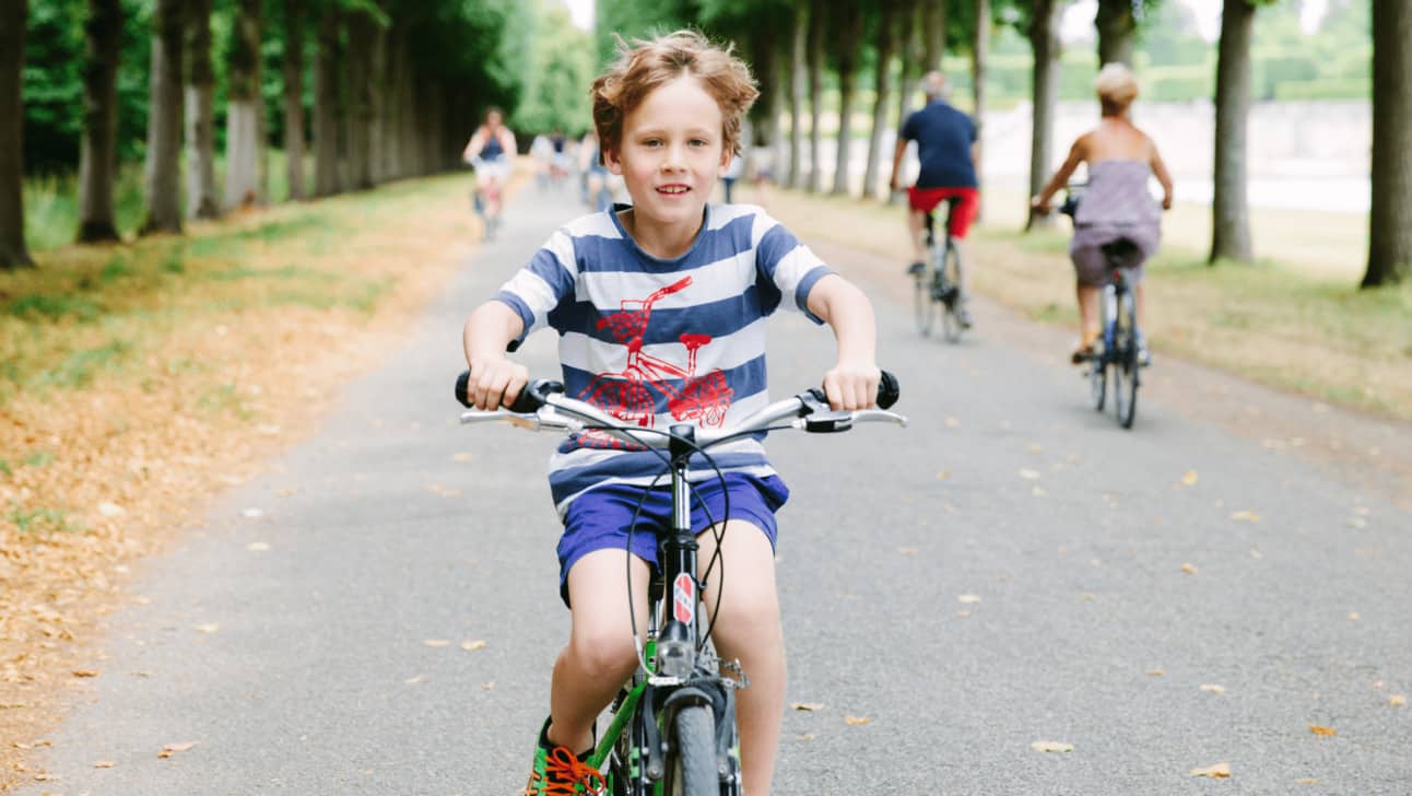 A young boy riding a bike