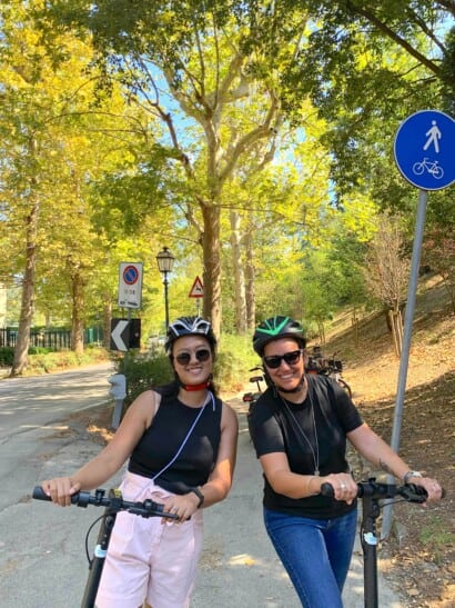 two guests on e-scooters enjoying riding through Florence, Italy