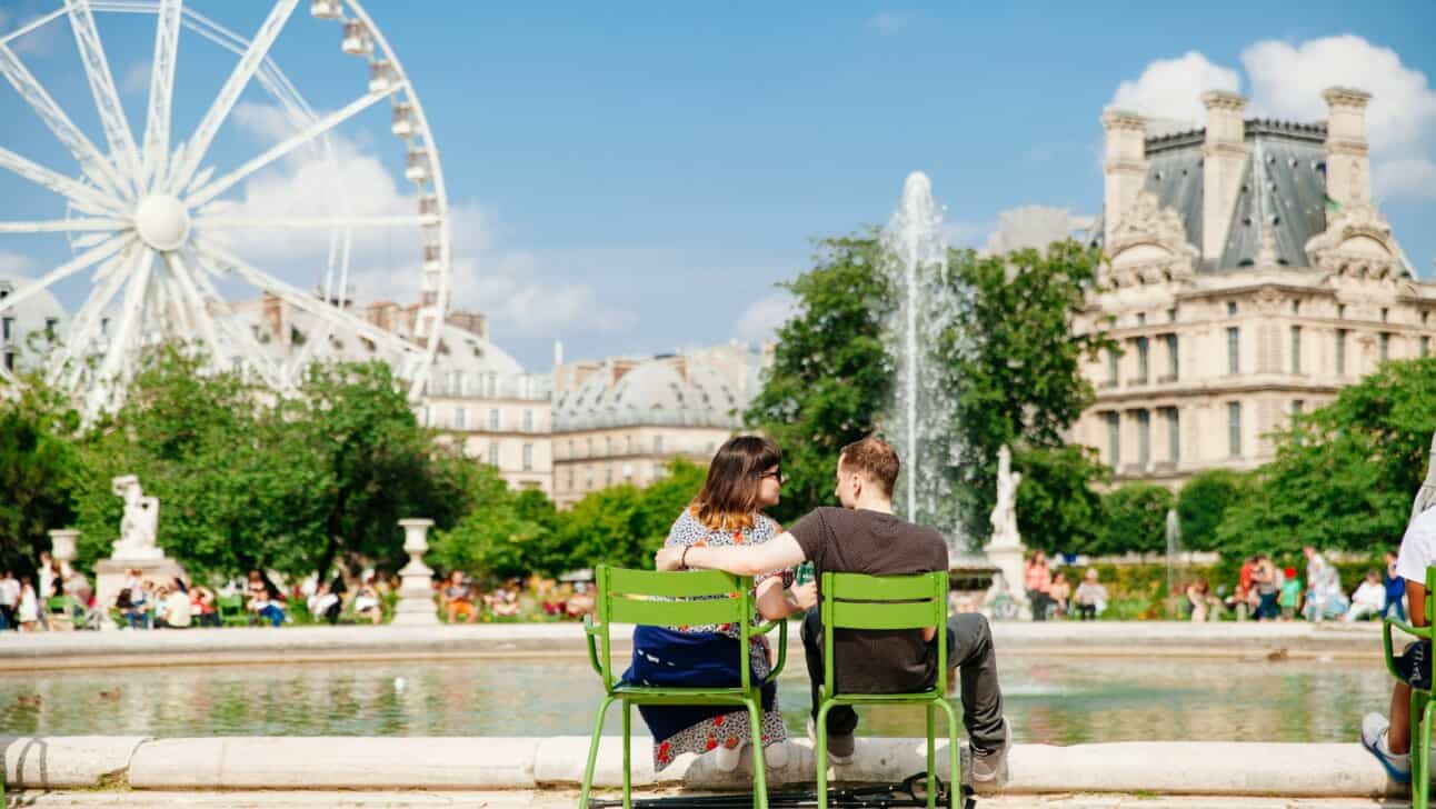 A couple relaxing in the Tuileries Gardens in Paris, France