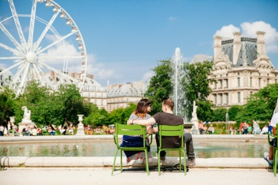 A couple relaxing in the Tuileries Gardens in Paris, France