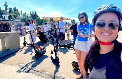 A group on e-scooters poses for a photo in Florence, Italy