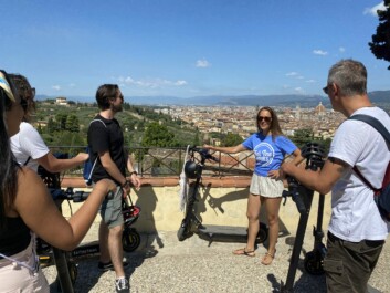 A private group on e-scooters enjoys the panoramic view over Florence, Italy