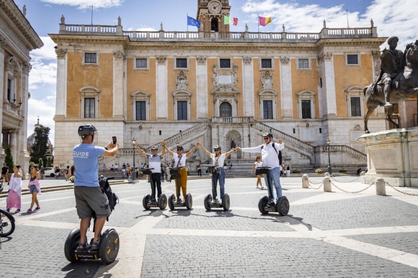 A family poses for a fun photo while on Segways in Rome, Italy