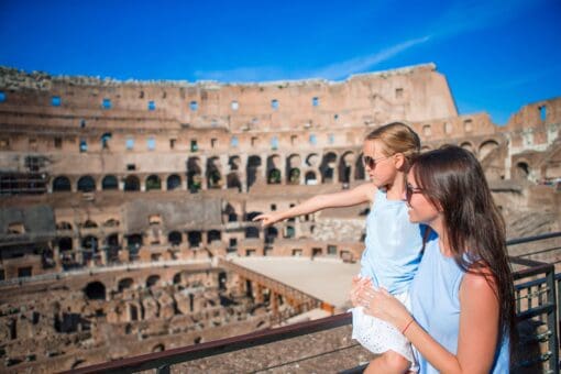 A mother and daughter look at the Colosseum in Rome, Italy