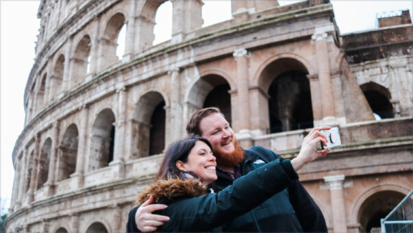 People taking photos in front of the colosseum.