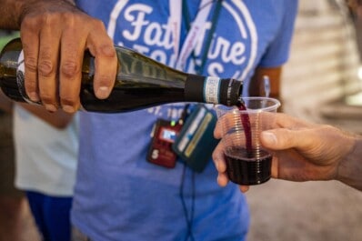 A guide pours a glass of local red wine