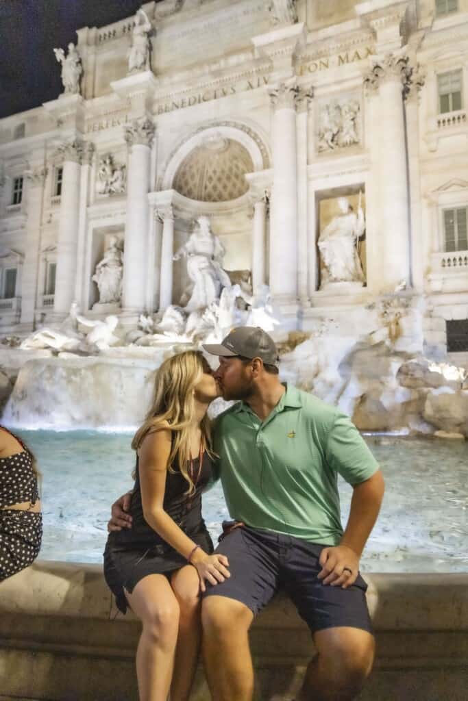 A couple kisses in front of the Trevi Fountain in Rome, Italy