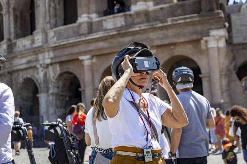A women uses a VR headset to see ancient Rome during a Segway Tour