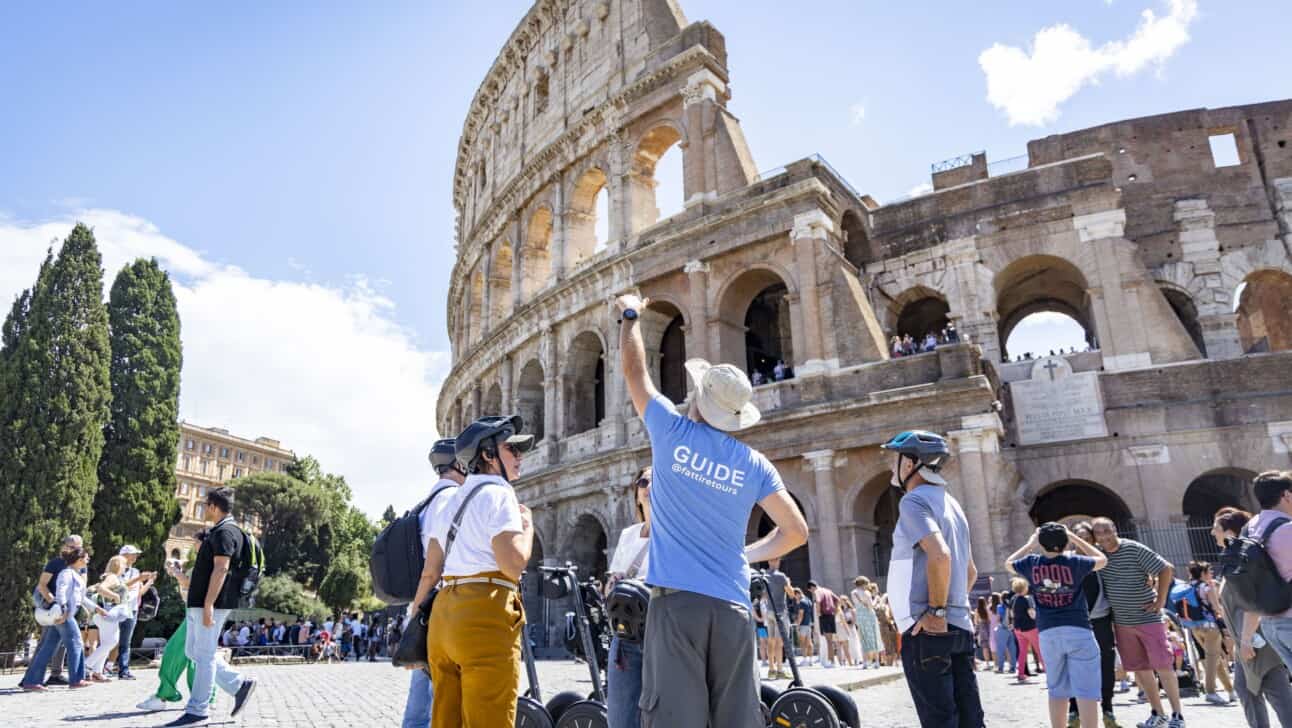 The guide explains the history of the Colosseum on a Rome Segway Tour