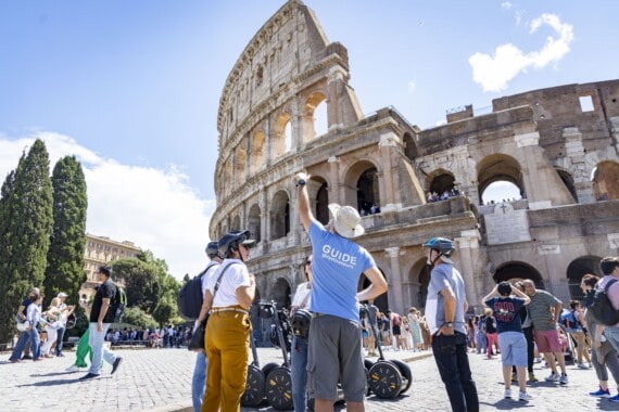 The guide explains the history of the Colosseum on a Rome Segway Tour