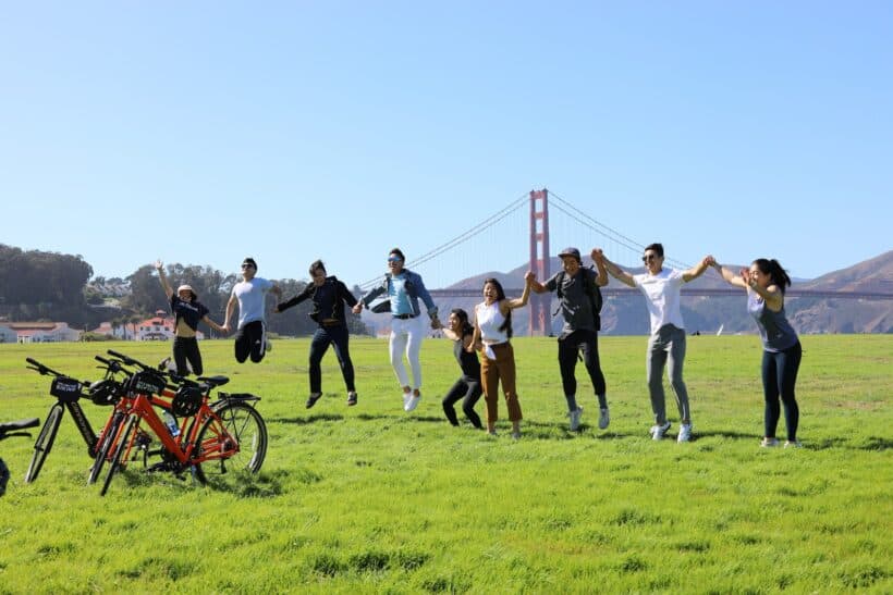 A group jumps for a photo in front of the Golden Gate Bridge in San Francisco, California