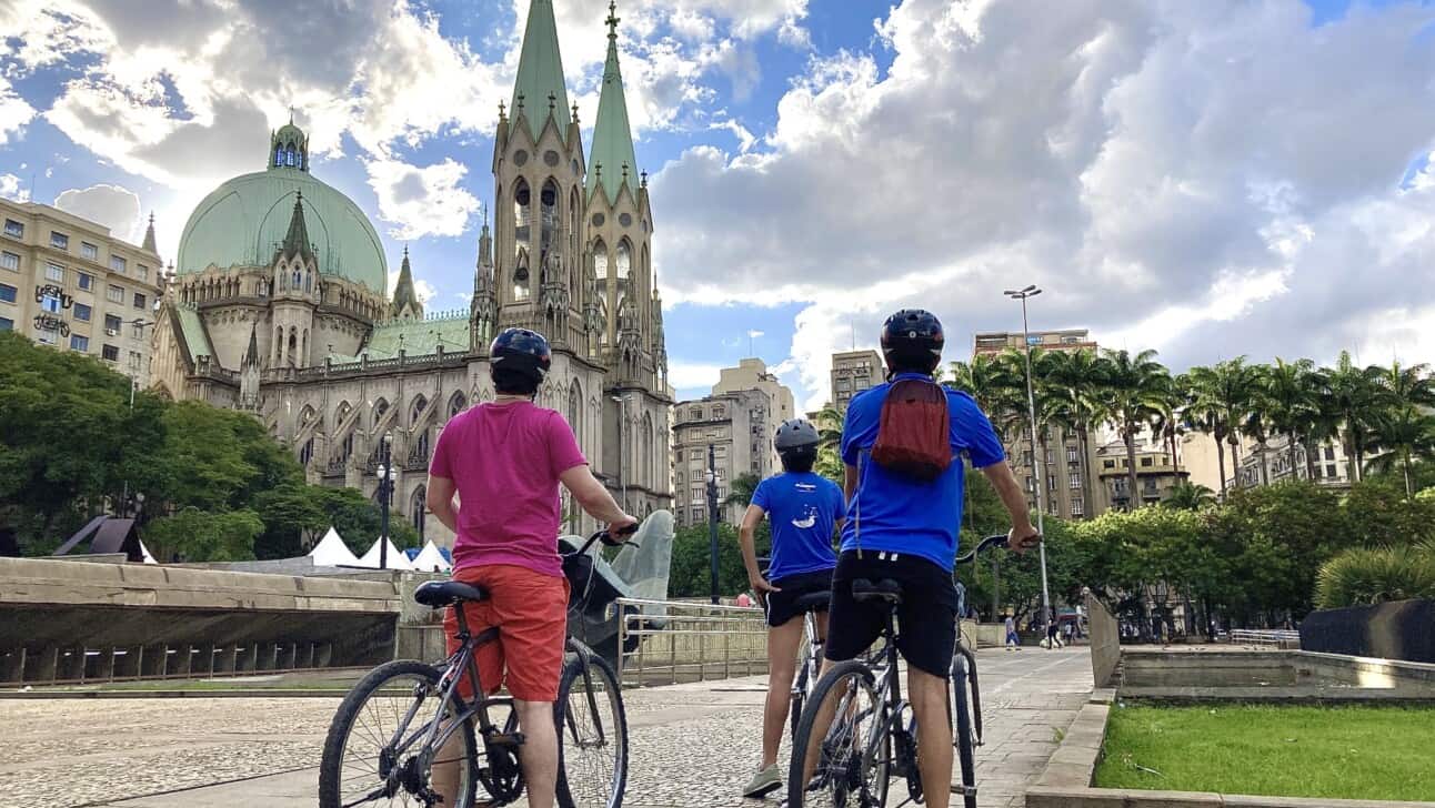 3 bike riders enjoy the view of the cathedral in Sao Paulo