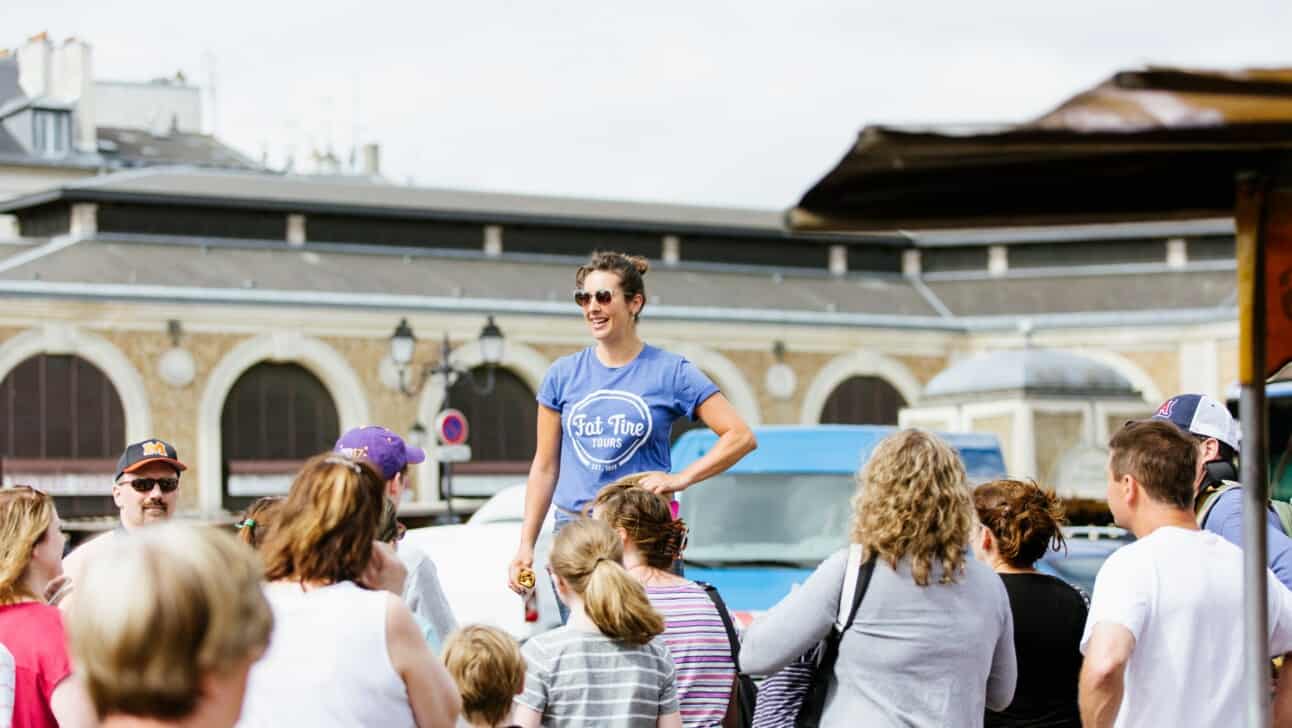 A guide addresses the group in Versailles