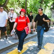 A group walks along a cobbelstone road