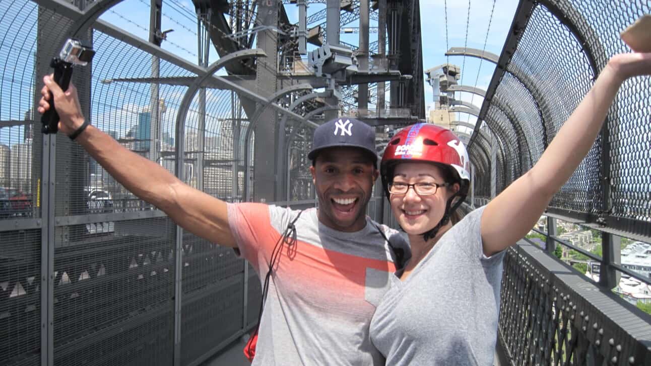 A couple crosses the famous Sydney Harbour Bridge