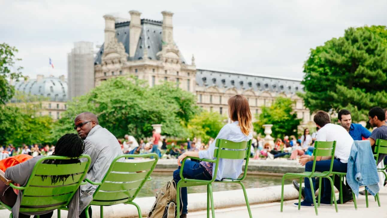 People enjoy a break in the Tuileries Gardens in Paris, France