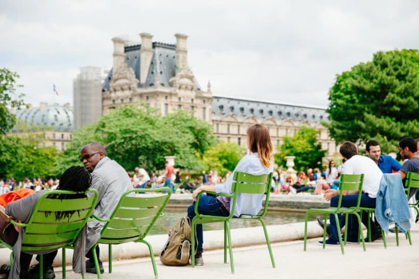 People enjoy a break in the Tuileries Gardens in Paris, France