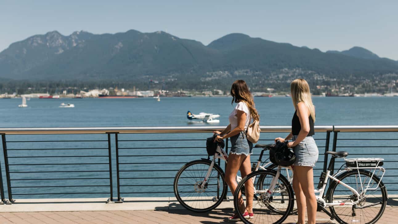 Two women look out over the sea in Vancouver, Canada