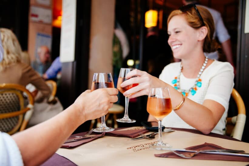 Two people enjoy a glass of wine in Paris, France