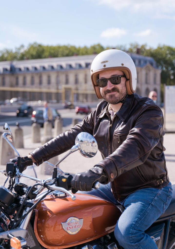 A man on a motorcycle with a sidecar in Versailles, France