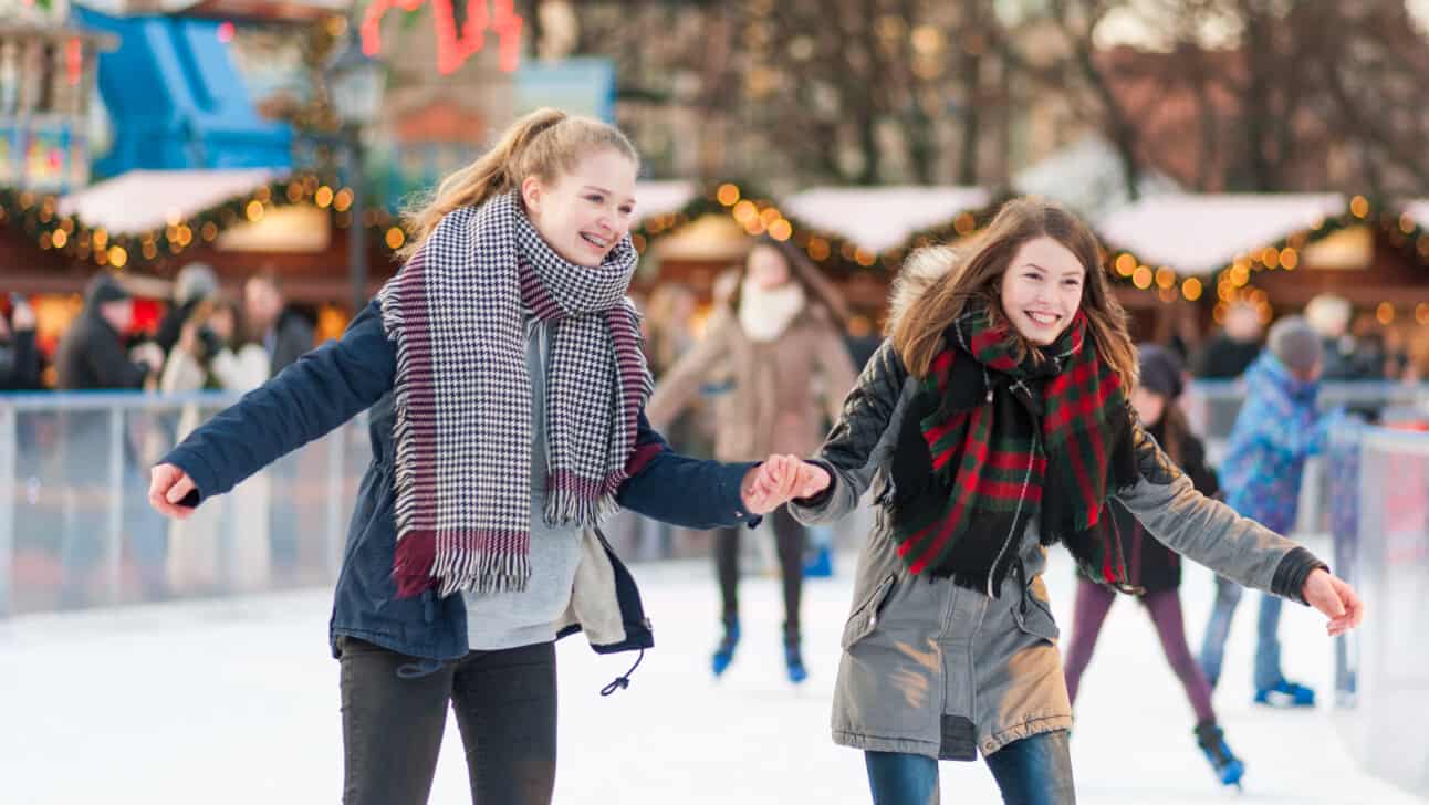 Two woman skating at the Neptunbrunnen ice rink in Berlin, Germany