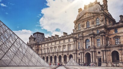 The courtyard and pyramid of the Louvre on a sunny day in Paris, France