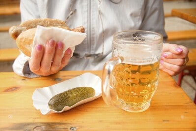 Beer, a bratwurst, and a pickle at a Berlin beer garden