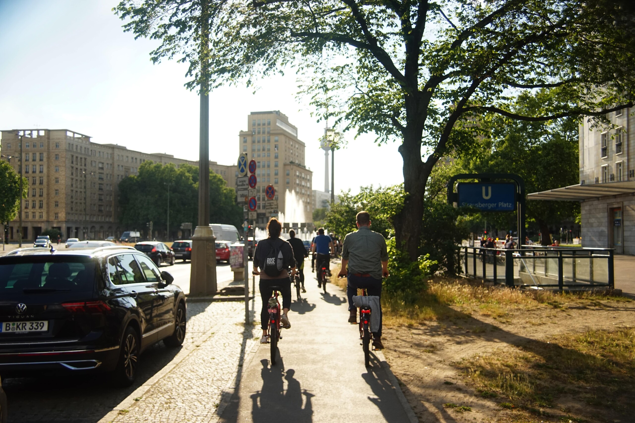 A group of cyclists ride along Karl Marx Allee in Berlin, Germany