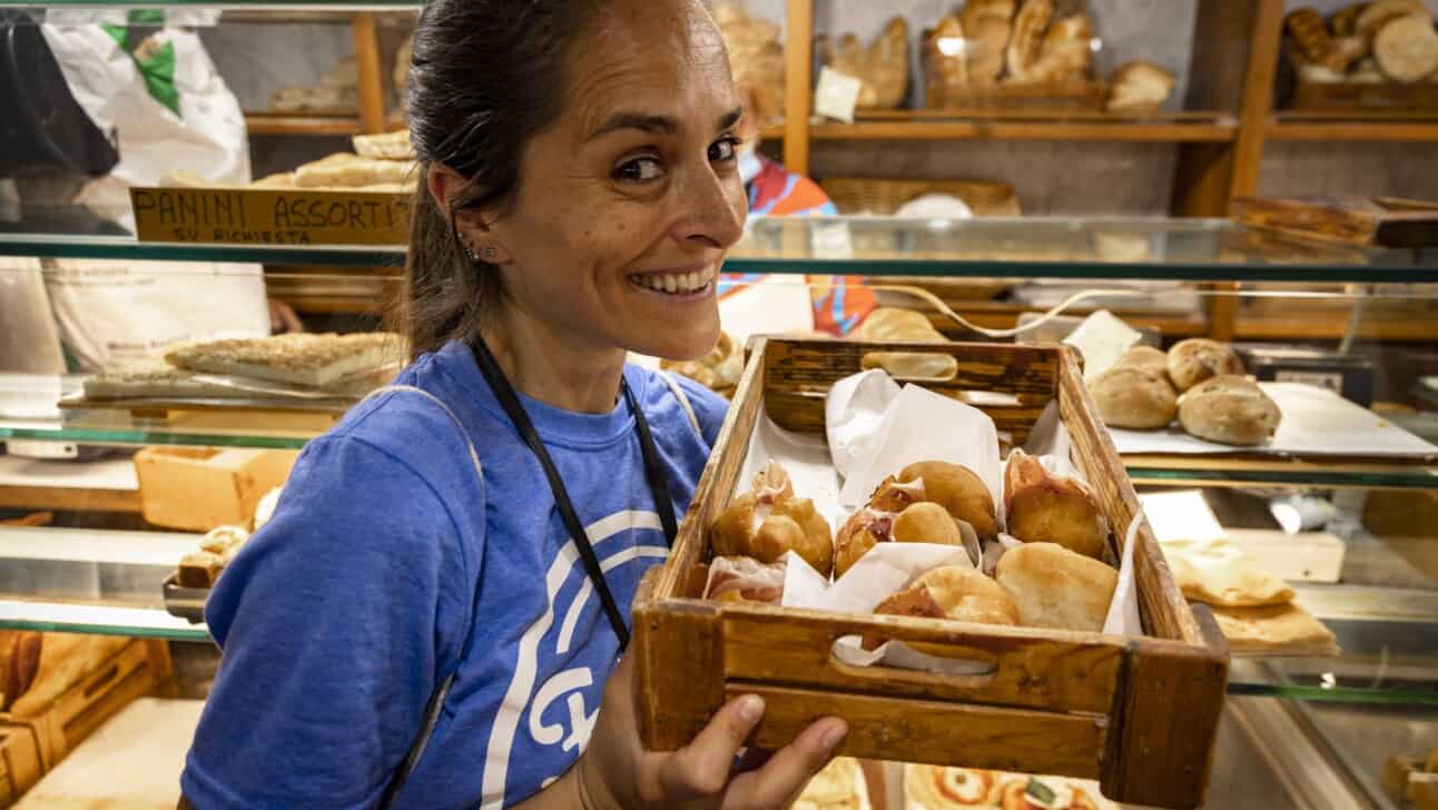 The guide holds up a basket of coccolo