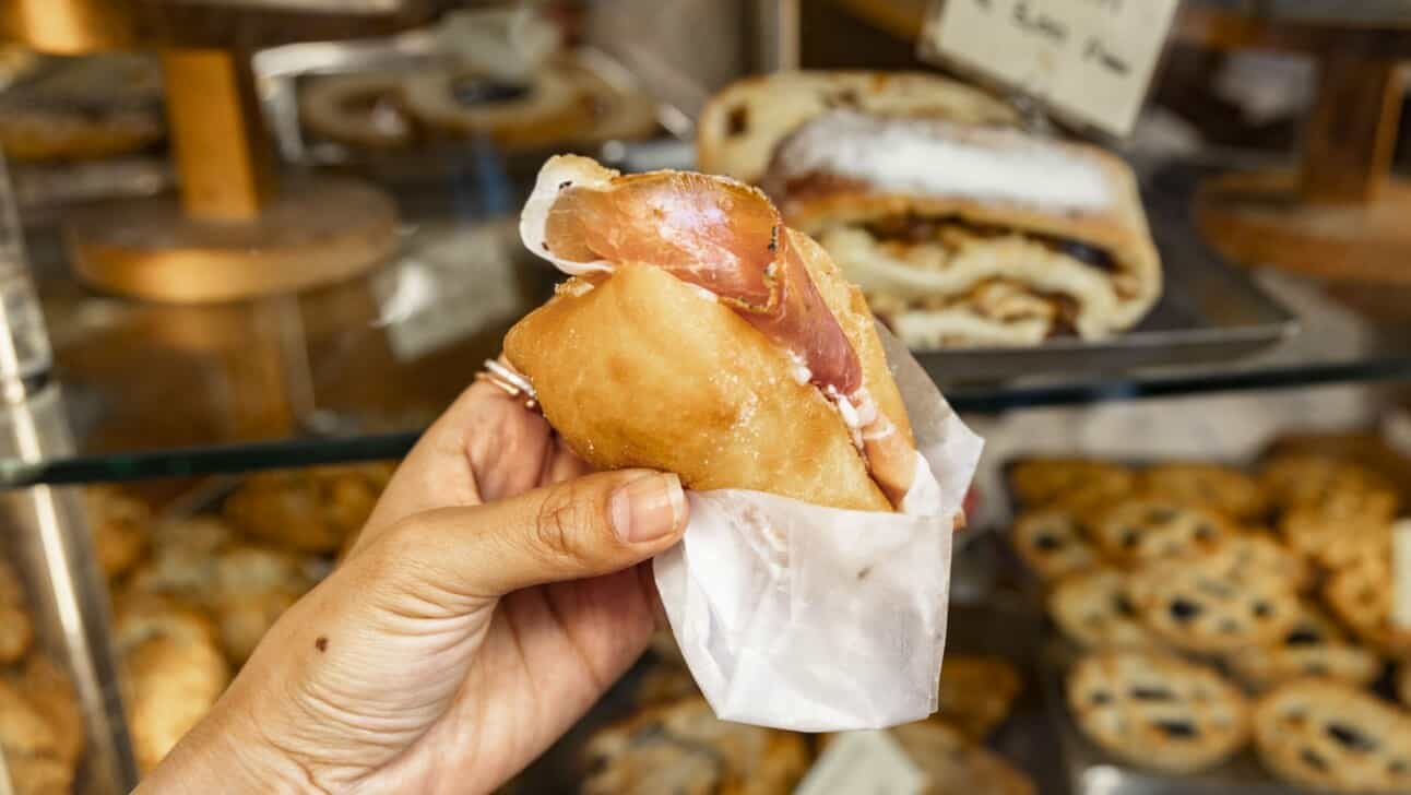 An authentic coccolo; soft cheese and ham in fried pizza dough
