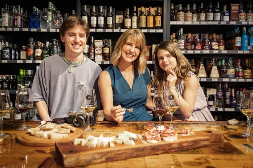 A family smiles for a photo during a wine tasting in Florence, Italy