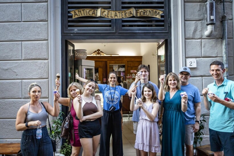A group poses for a photo in front of a gelateria in Florence, Italy