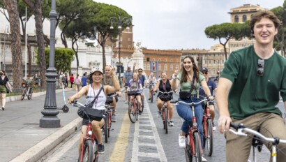 A group of cyclists rides through the heart of Rome, Italy